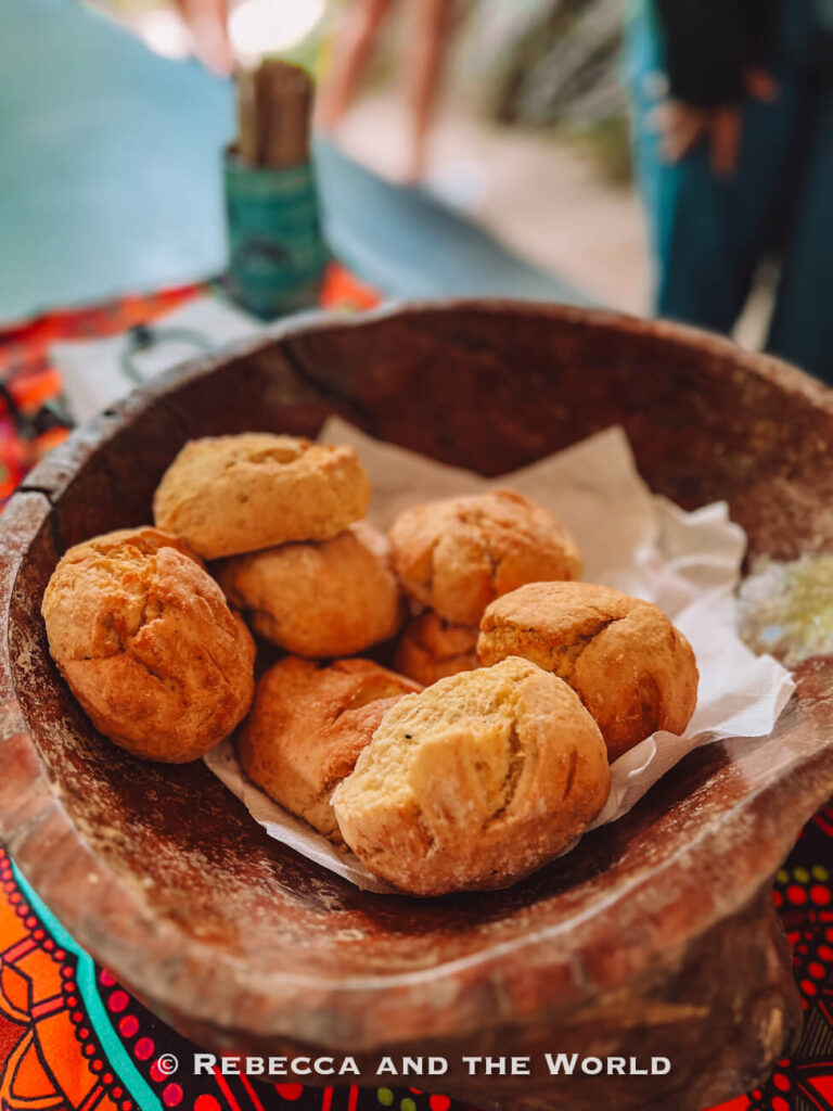 A wooden bowl of freshly baked damper served with honey and billy tea at the end of the Ngadiku Dreamtime Walk in Mossman Gorge